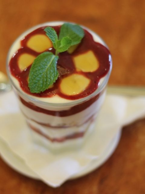 Elegant layered dessert with berry compote and fresh mint